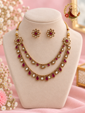 Ruby and white kundan gold-finish two-strand necklace set with flower stud earrings on a display bust, Zari and Gota UK