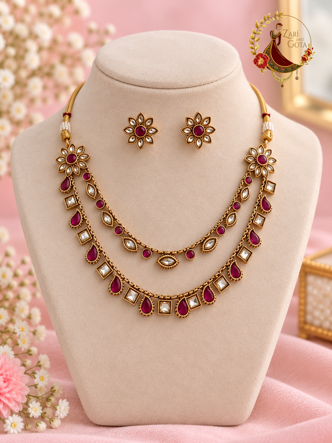 Ruby and white kundan gold-finish two-strand necklace set with flower stud earrings on a display bust, Zari and Gota UK