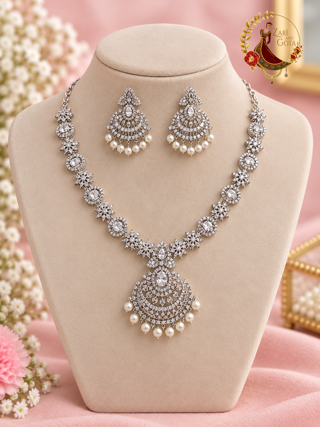 Silver-tone American diamond necklace with pearl-fringed chandbali pendant and matching earrings on a display bust, Zari and Gota UK