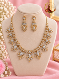 Gold-tone American diamond floral cluster necklace with matching drop earrings on a display bust, Zari and Gota UK