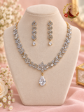 Gold-tone American diamond leaf-cluster necklace with clear pear solitaire drop and matching earrings on a display bust, Zari and Gota UK