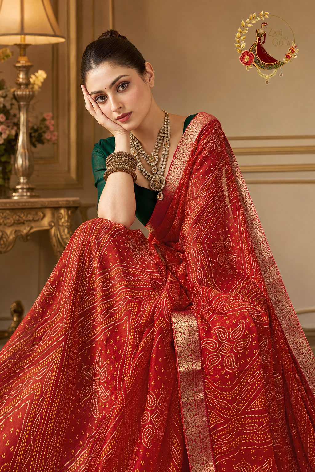Close view of the cream and yellow bandhani dot bands on red chiffon
