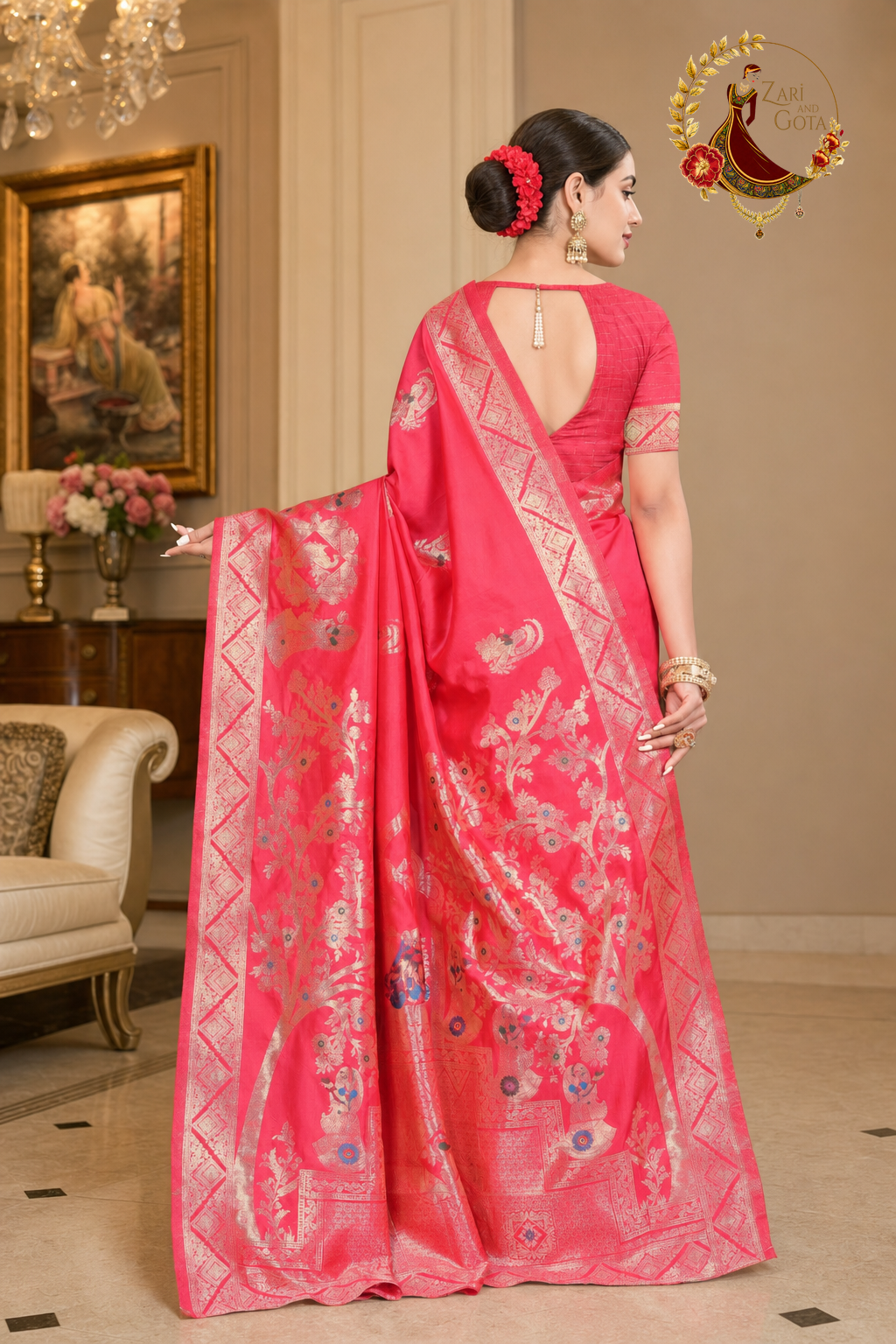 Back view of the coral pink Dola silk Banarasi saree showing the blouse with pearl latkan closure and the zari pallu