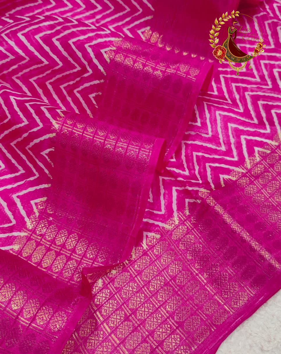 Close view of the fine white chevron print on magenta pink cotton silk
