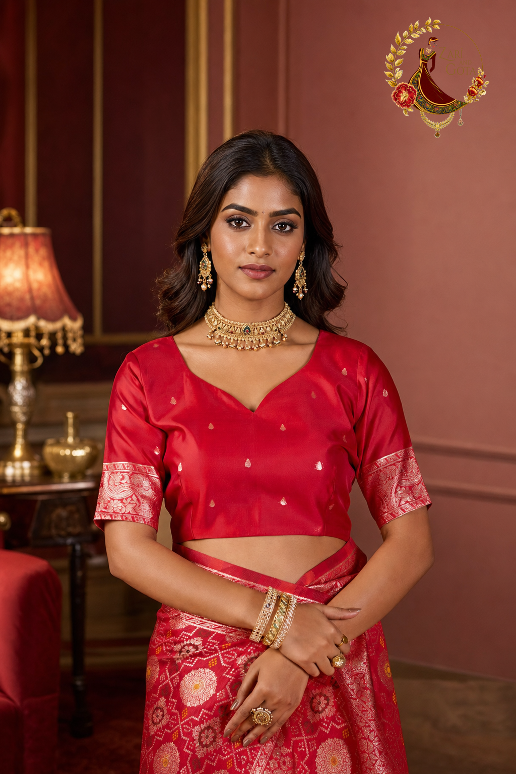Detail of red silk blouse with gold butti and zari woven sleeve band