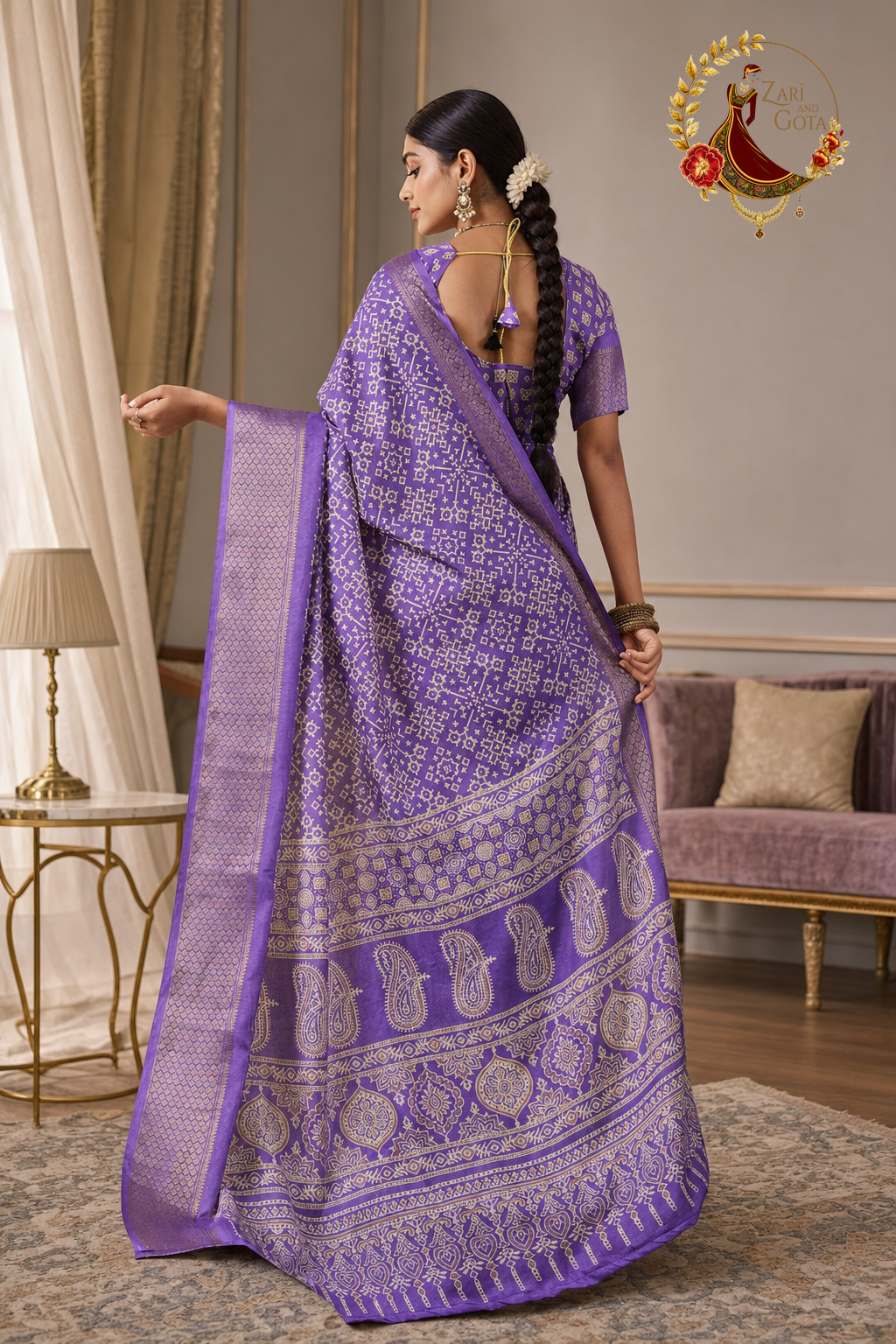 Back view of lavender printed saree showing paisley pallu and zari bands