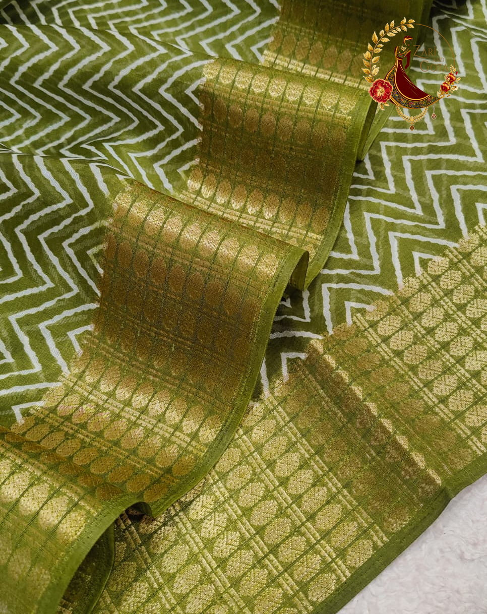 Close view of the fine white chevron print on olive green cotton silk