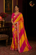 Magenta pink and golden yellow cotton silk Banarasi saree with silver zari border, worn by a model