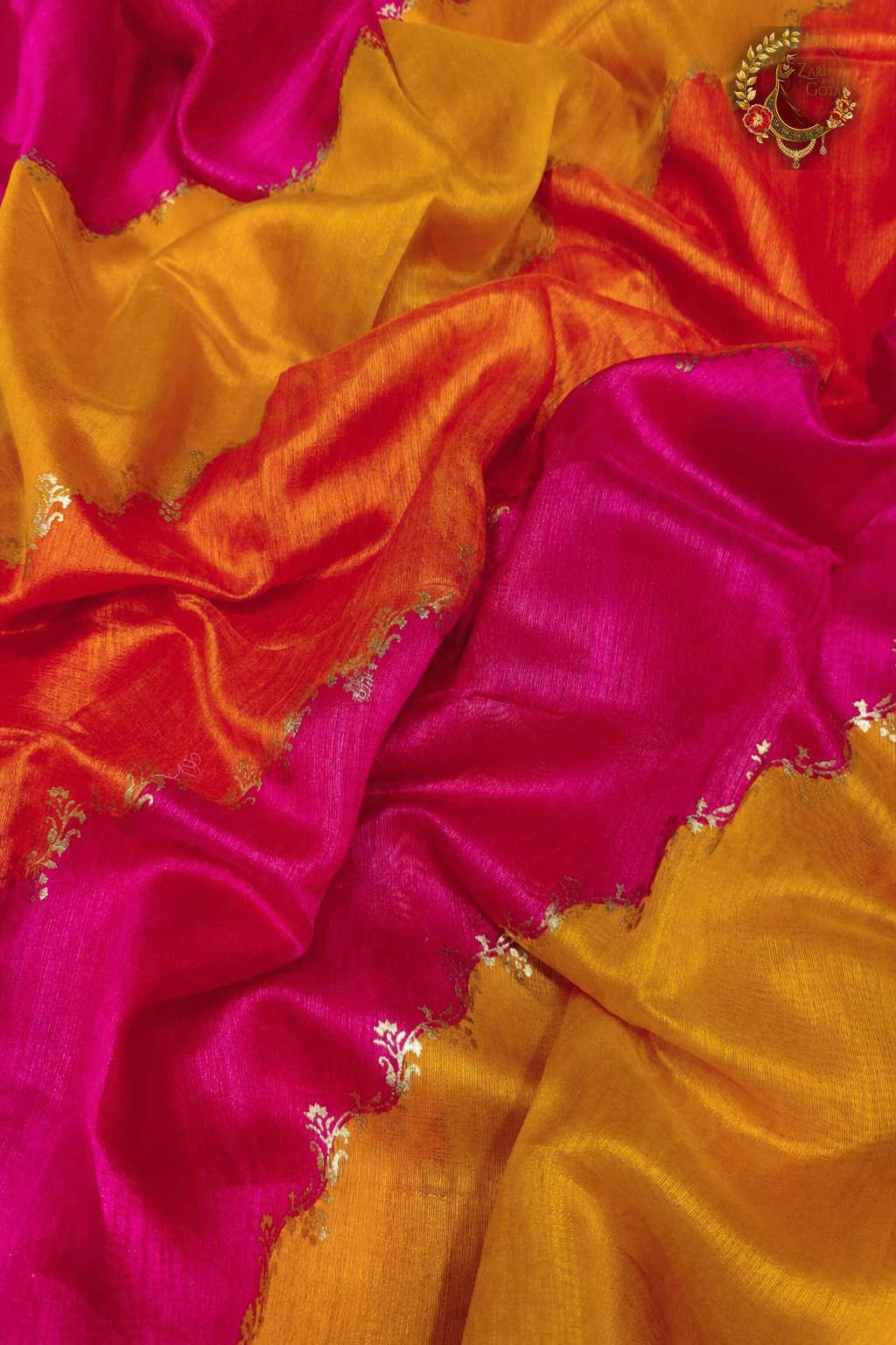 Detail of scalloped gold embroidered join between pink and golden yellow sections