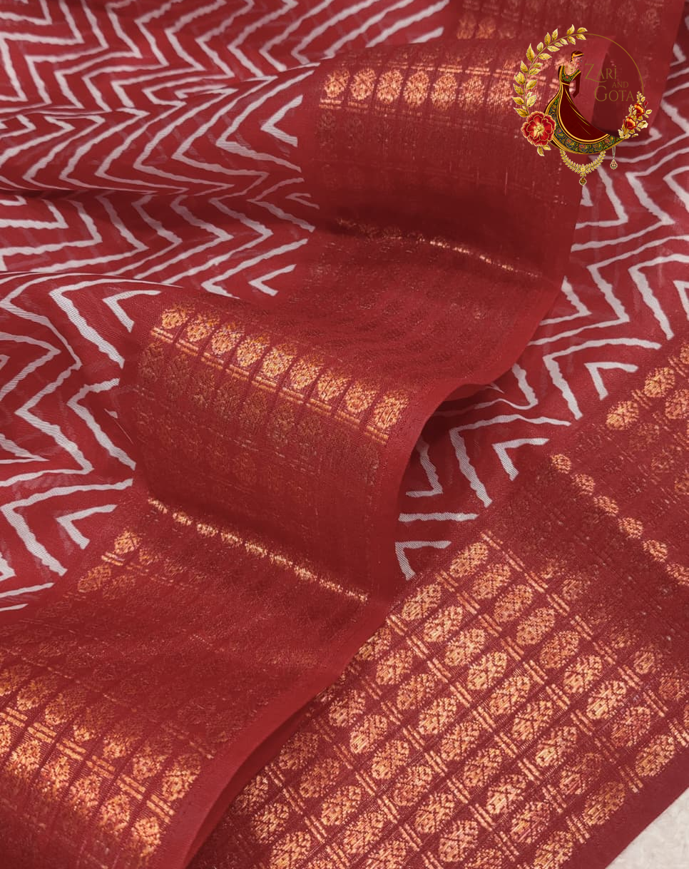 Close view of the fine white chevron print on maroon cotton silk