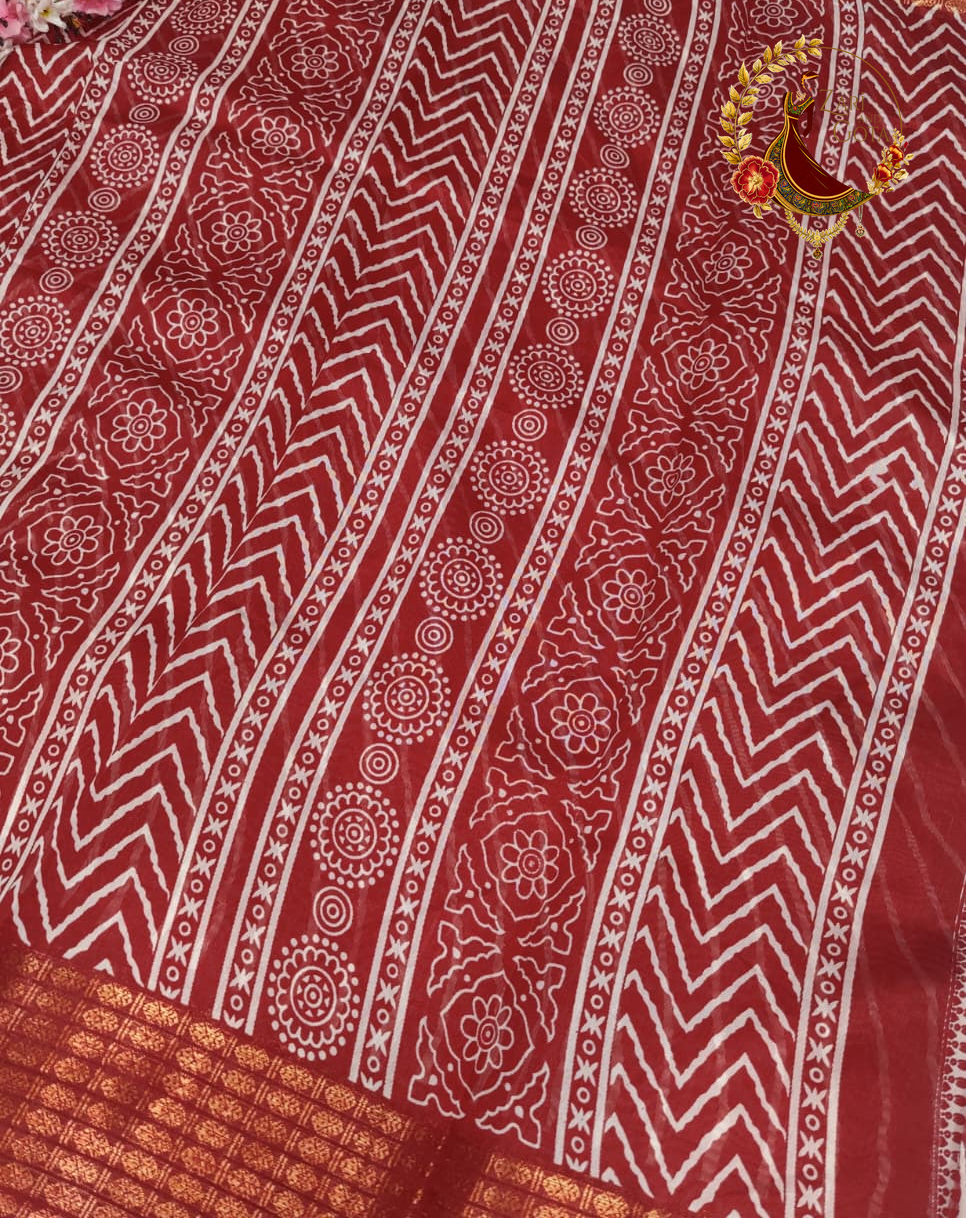 Printed motif bands running down the pallu of the maroon cotton silk saree