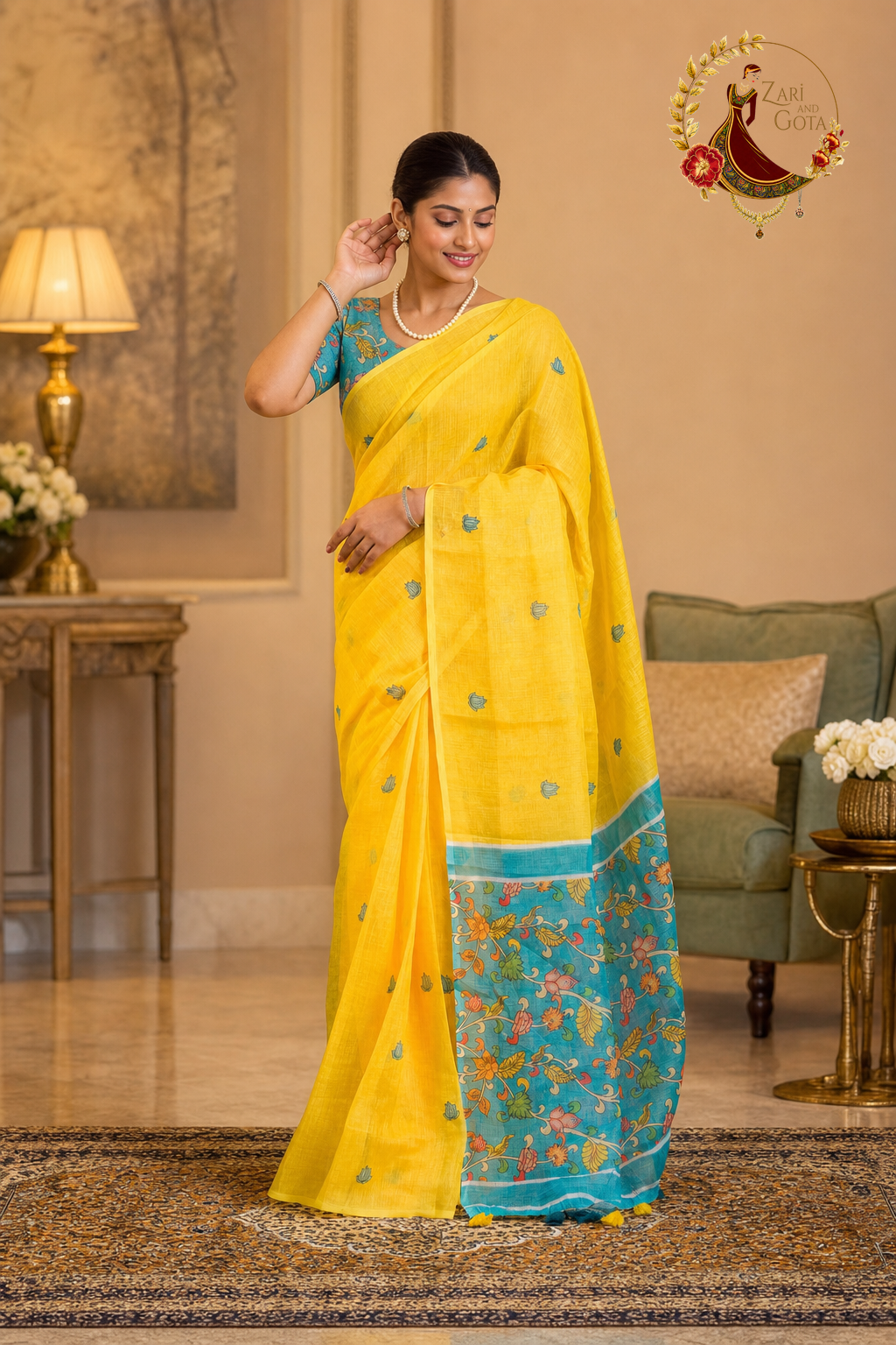 Marigold yellow kalamkari cotton saree with teal printed border, worn by a model