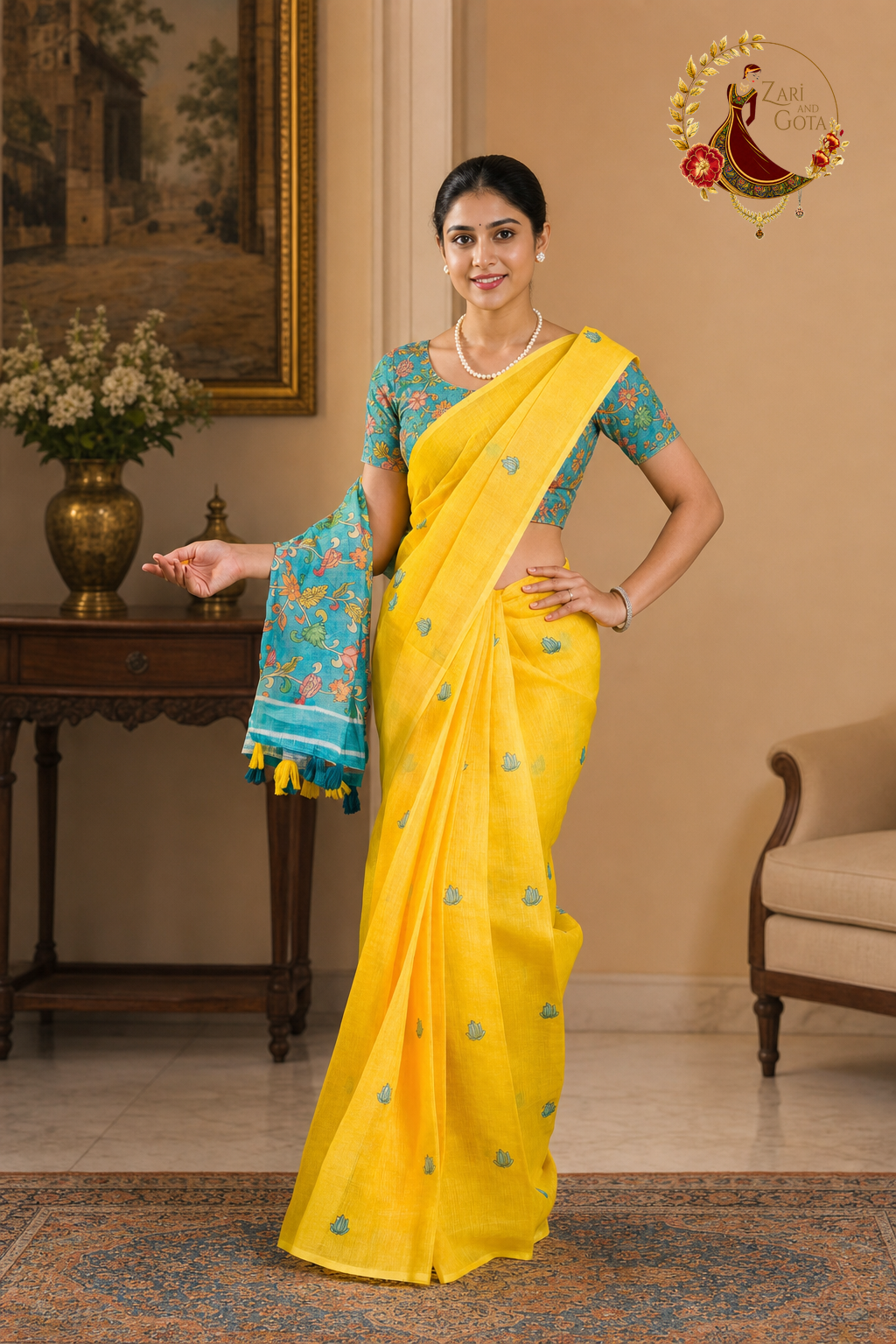 Yellow kalamkari saree with teal tasselled pallu held to the side