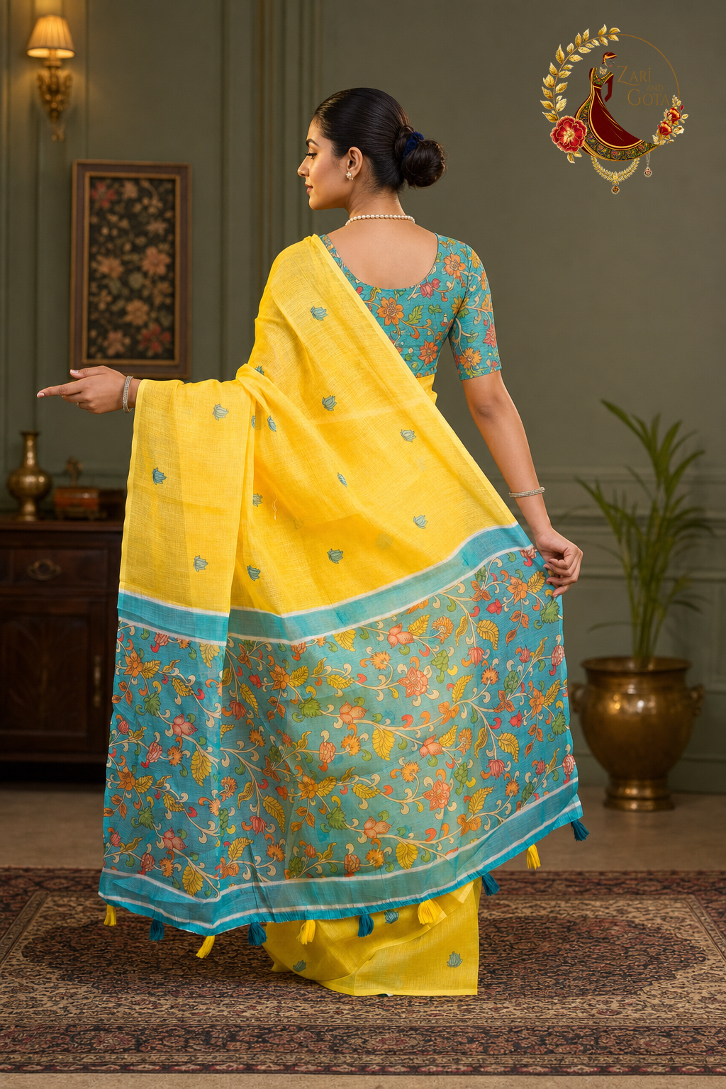 Back view of yellow kalamkari cotton saree showing the printed pallu spread out