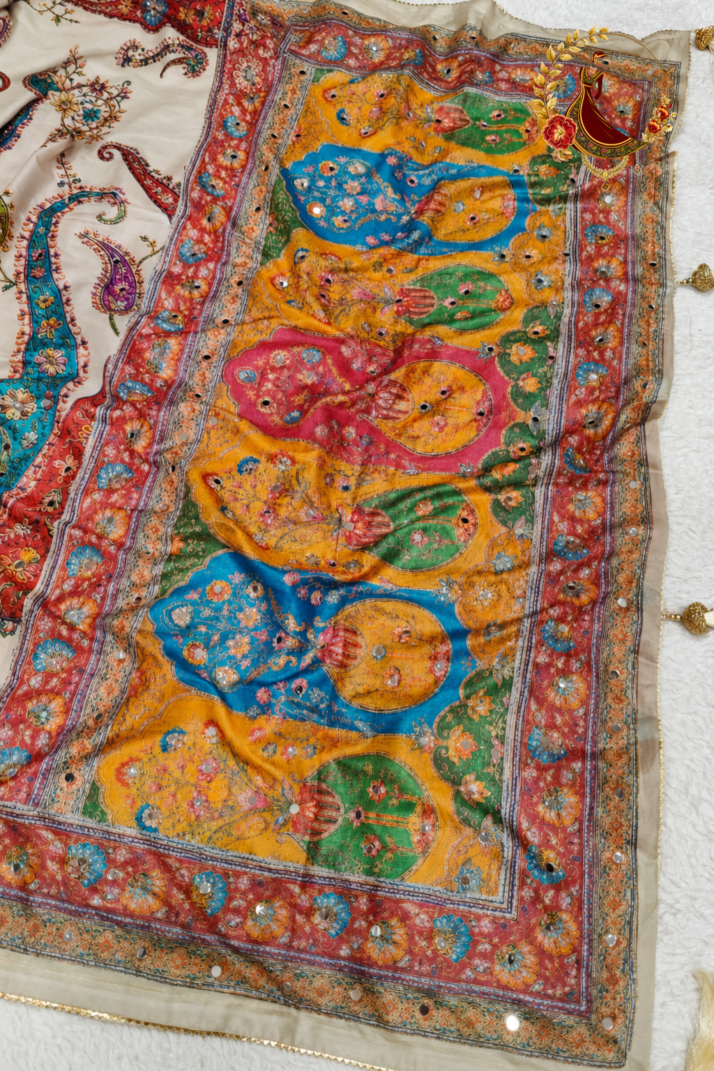 Detail of the pallu panels in mustard, blue and red paisley