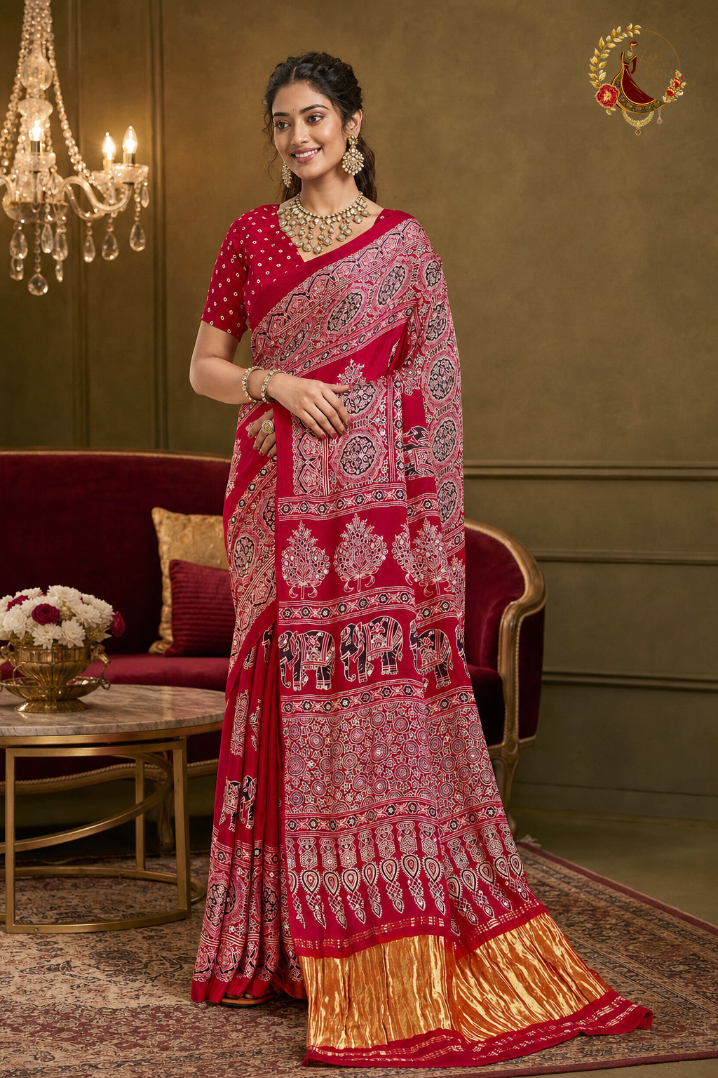 Deep red Gaji silk ajrakh saree with ivory elephant print and gold tissue border, worn by a model