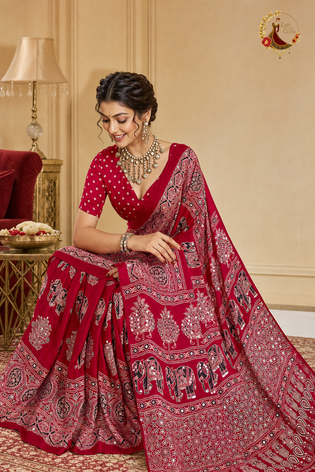 Red ajrakh saree showing elephant and tree-of-life block print across the pallu