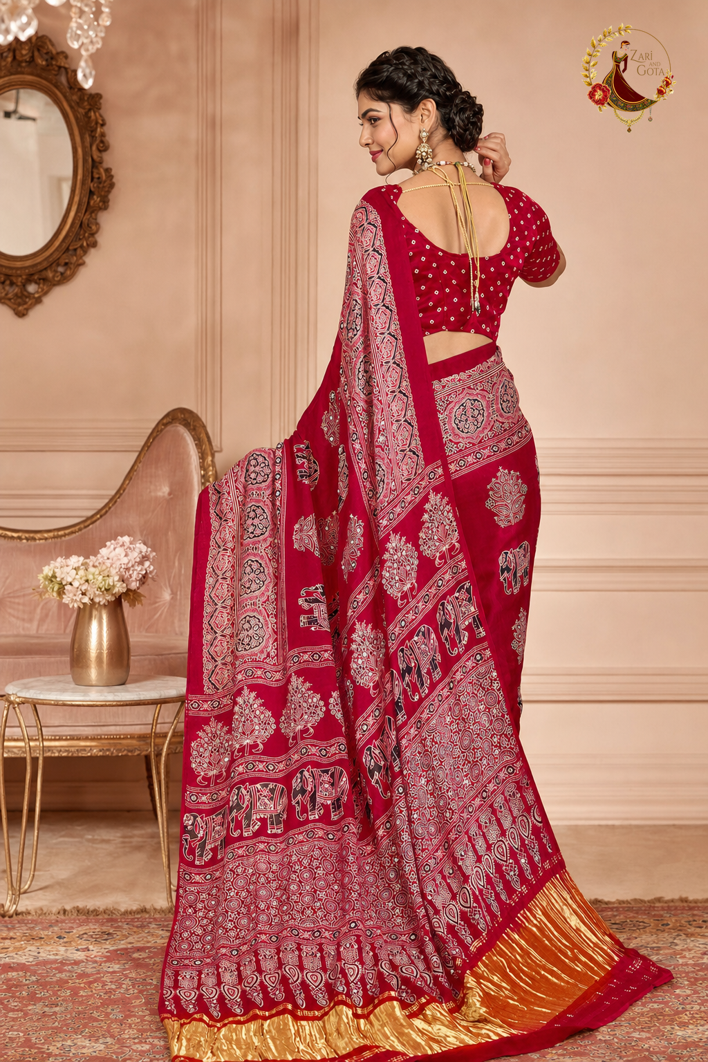 Back view of red ajrakh saree showing pallu spread and gold tissue hem border