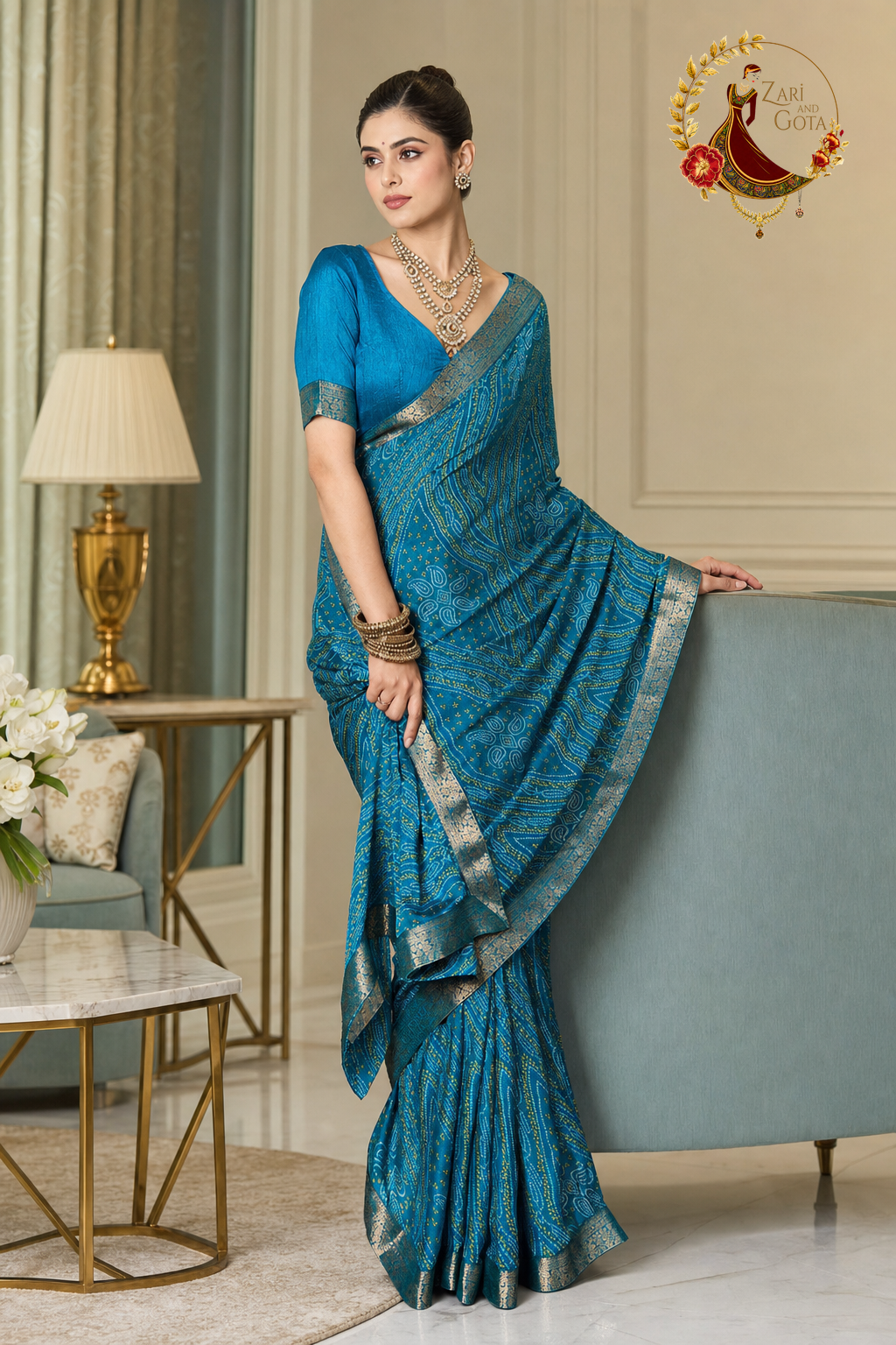 Turquoise blue bandhani print saree with the zari border held out