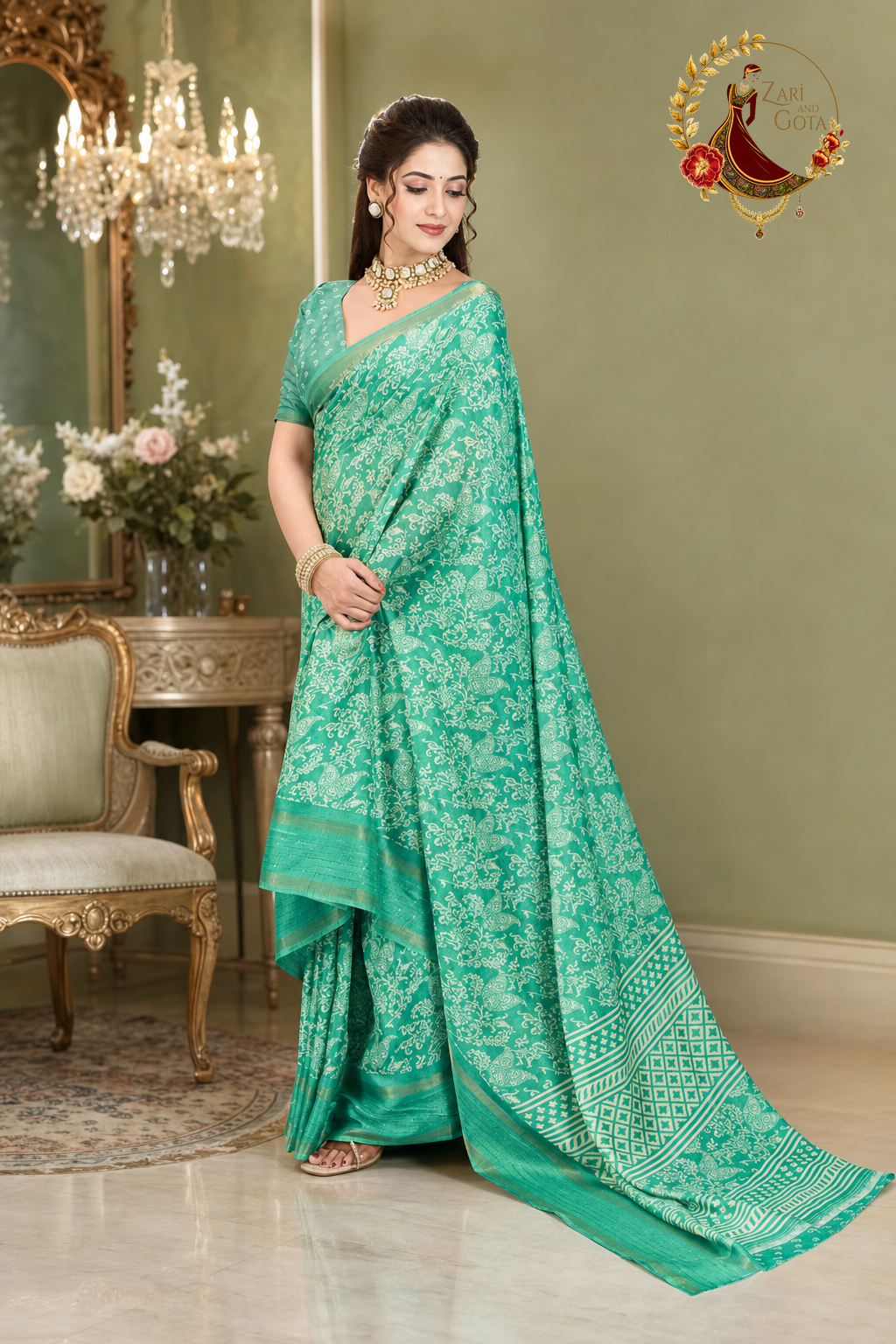 Sea green cotton silk saree with the printed pallu held out to show the drape