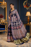 Navy blue Gaji silk ajrakh saree with red elephant print and gold-green tissue border, worn by a model