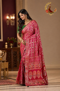 Rose pink upada silk ghatchola saree with gold zari grid and meenakari florals, worn by a model