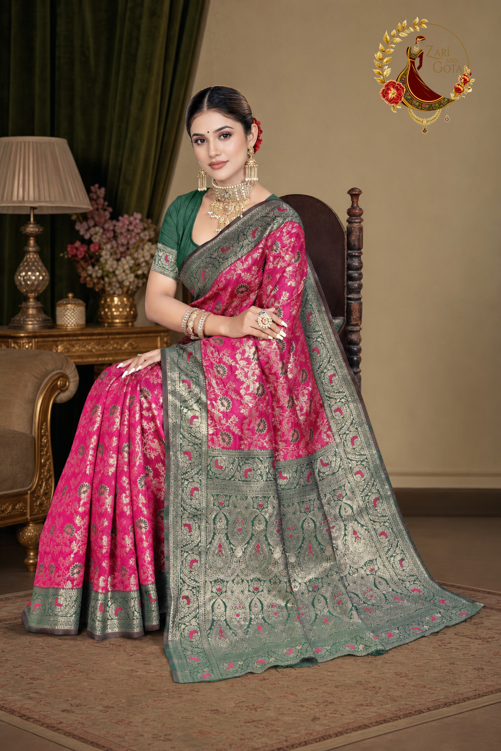 Seated view of the rani pink Banarasi silk saree showing the drape
