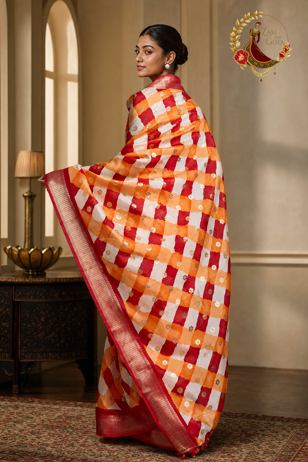 Back view of red and orange leheriya saree showing the pallu and zari border