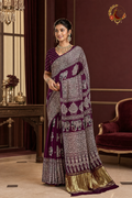 Deep plum Gaji silk ajrakh saree with ivory elephant print and gold tissue border, worn by a model