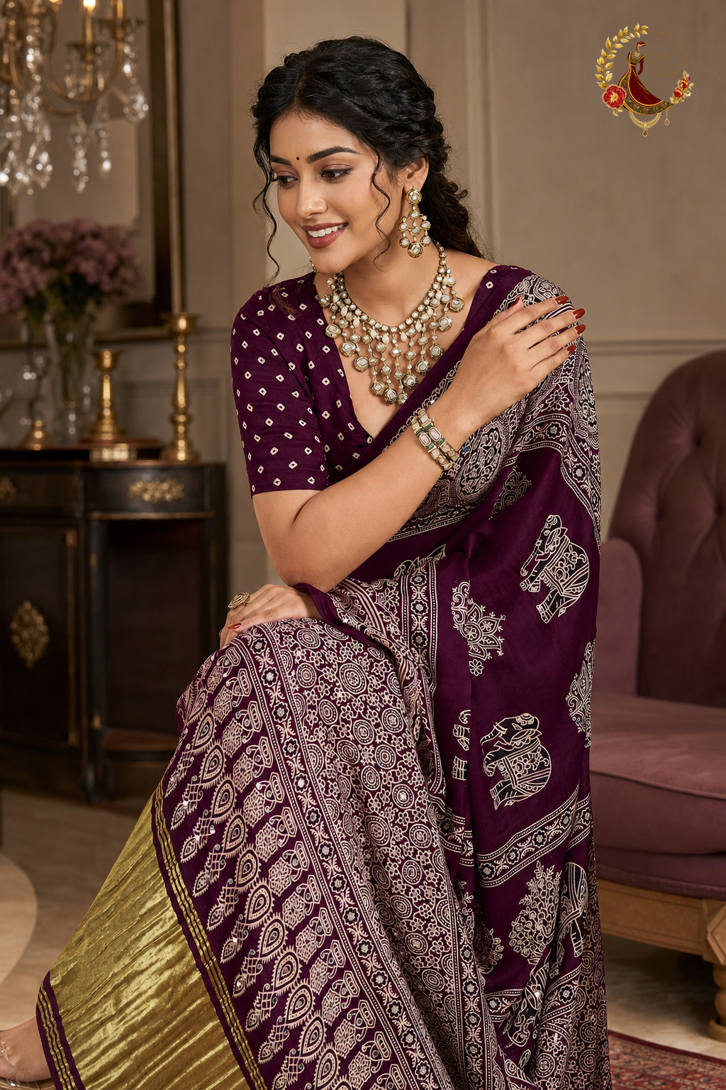 Seated view of plum Gaji silk saree showing elephant and medallion block print detail