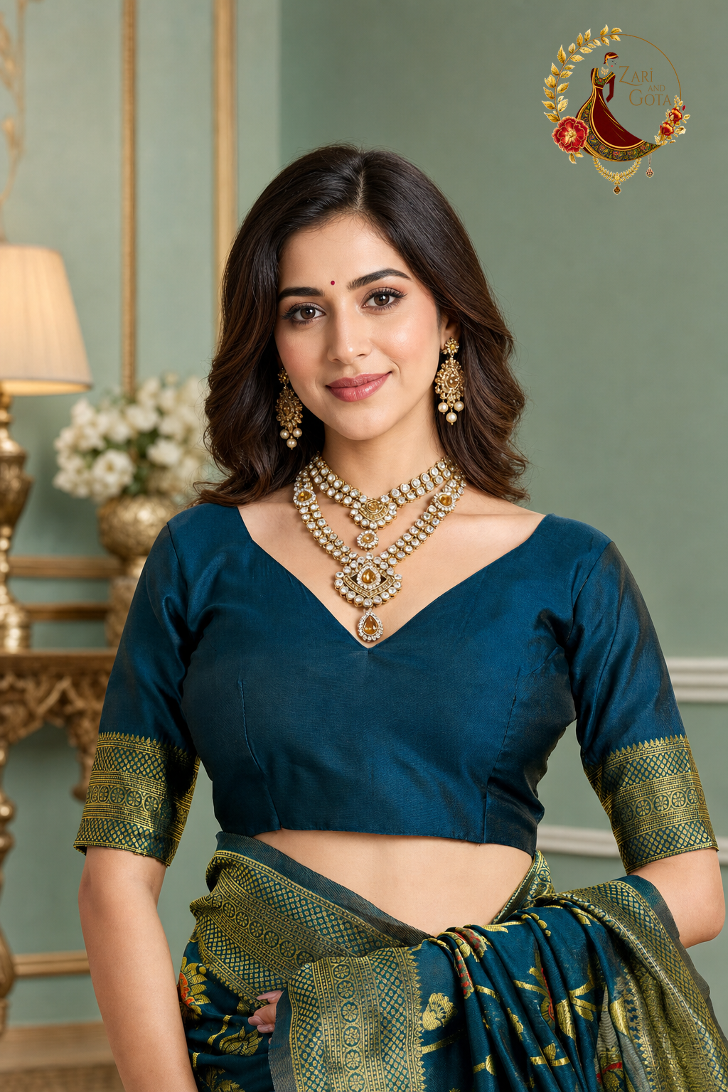 Detail of the peacock teal blouse with gold zari sleeve band