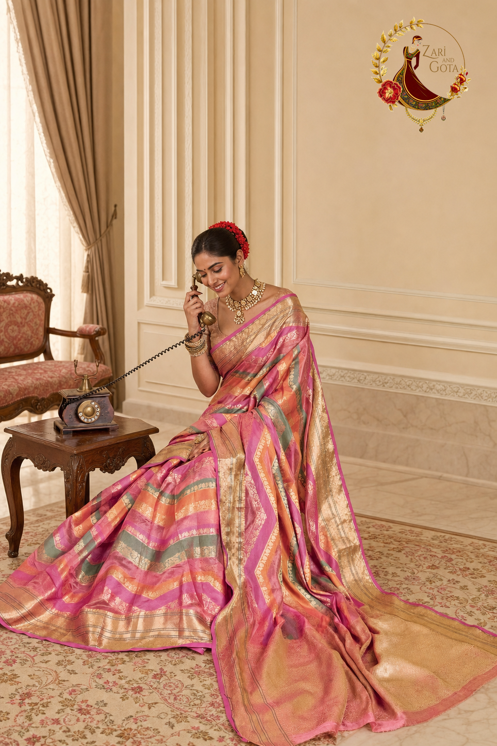 Seated view of pink and sage leheriya saree with gold zari bands