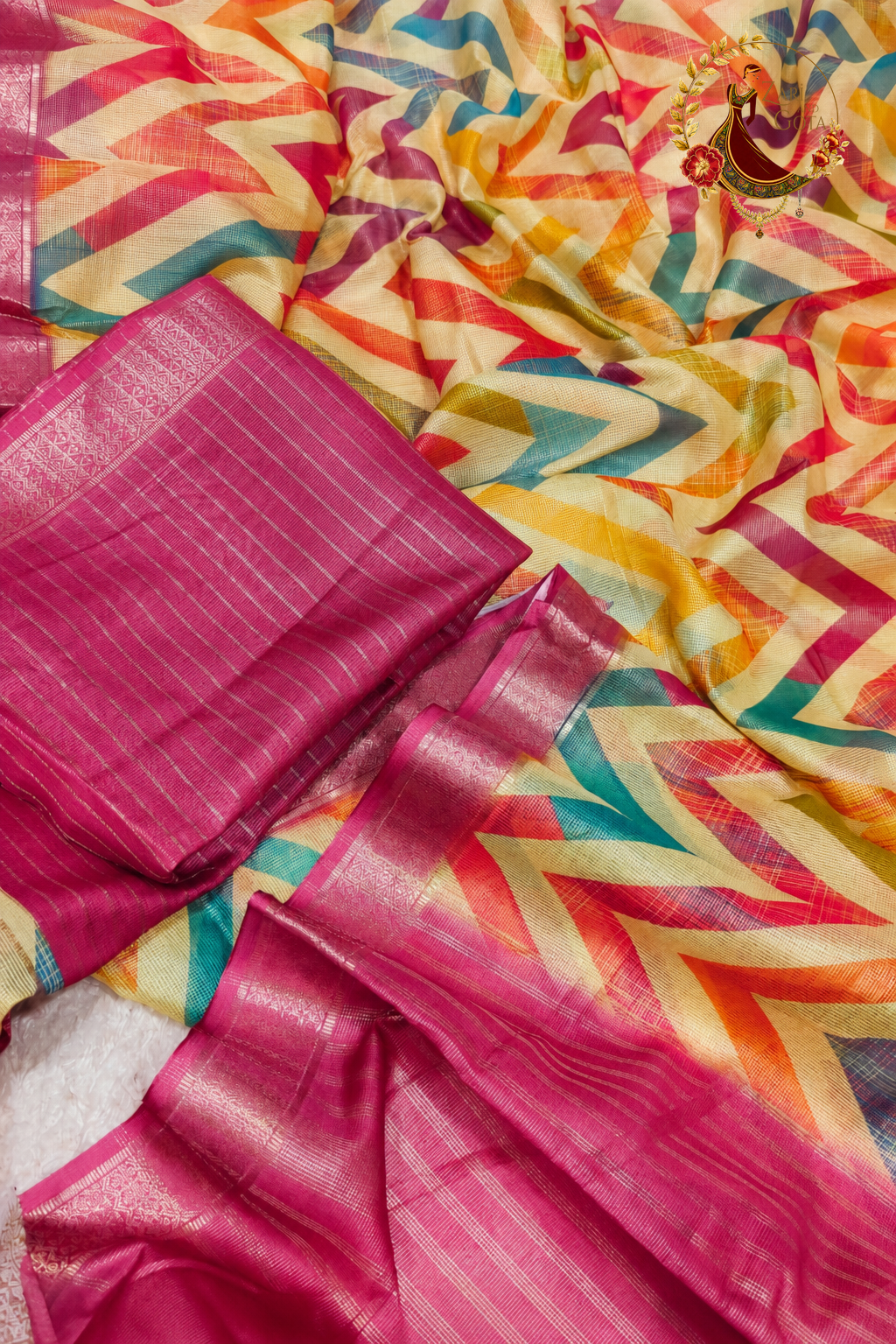 Folded tissue saree showing chevron print and rose pink zari border