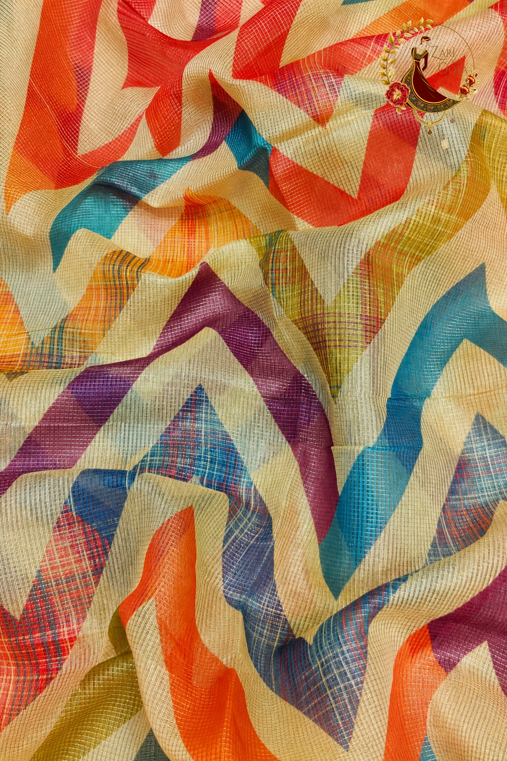Detail of multicoloured chevron print over the checked tissue ground
