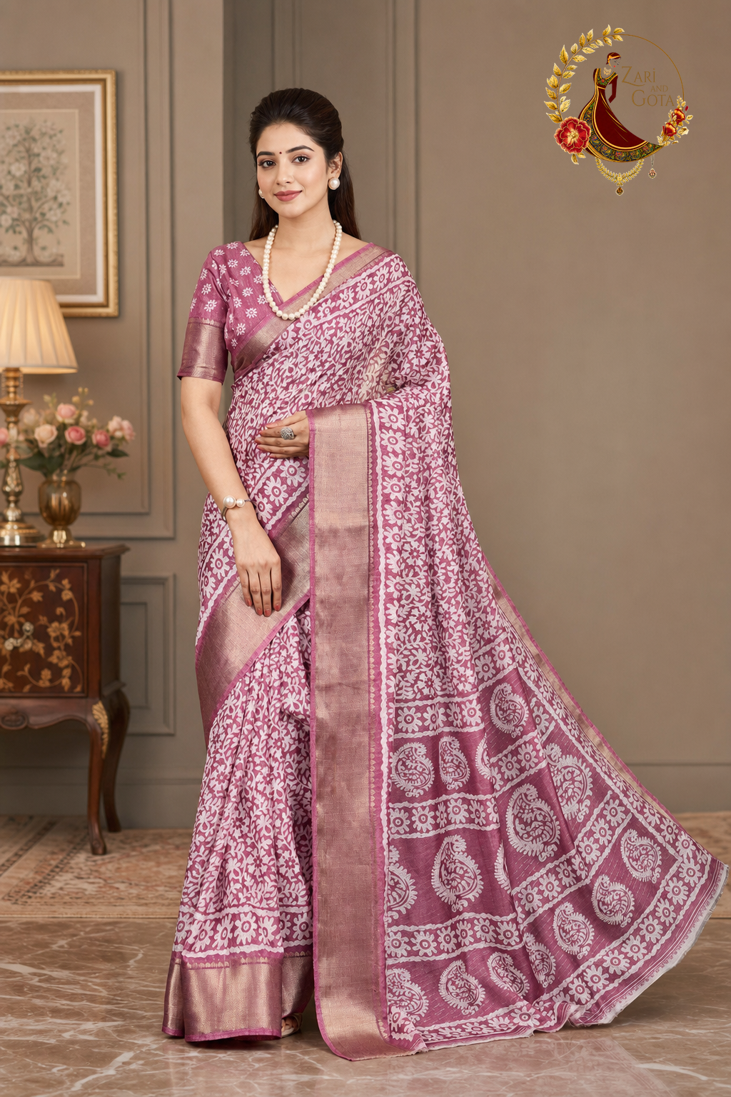 Side view of the dusty rose printed saree showing the rose-gold zari selvedge