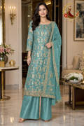 Turquoise green Banarasi silk unstitched suit set with all-over gold zari jaal, cutdana hem band and gold-bordered dupatta, worn by a model with palazzo, Zari and Gota UK