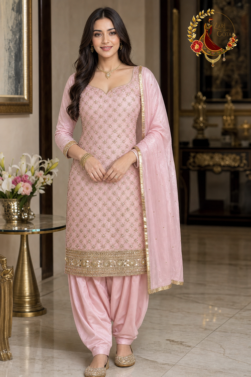 Baby pink crepe silk unstitched suit set with all-over gold zari trellis, beaded mirror hem band and gold-bordered tabby silk dupatta, worn by a model with Punjabi salwar, Zari and Gota UK