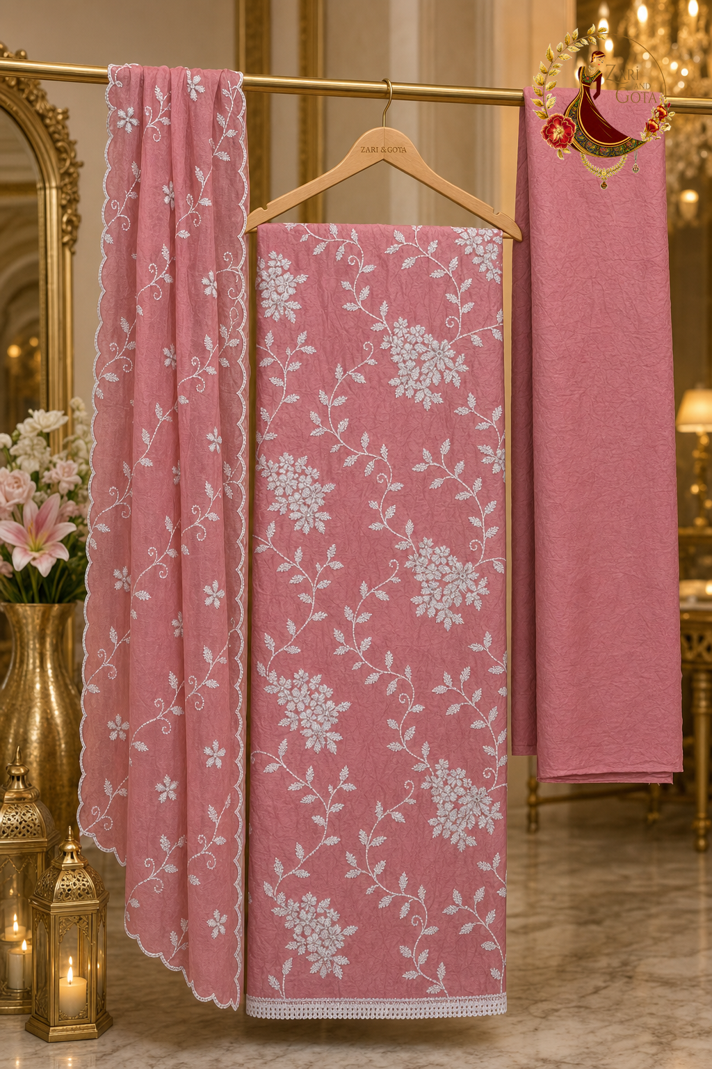 Unstitched peachy pink crushed cotton white thread embroidered suit set components displayed on a hanger: shirt fabric, kota dupatta and bottom