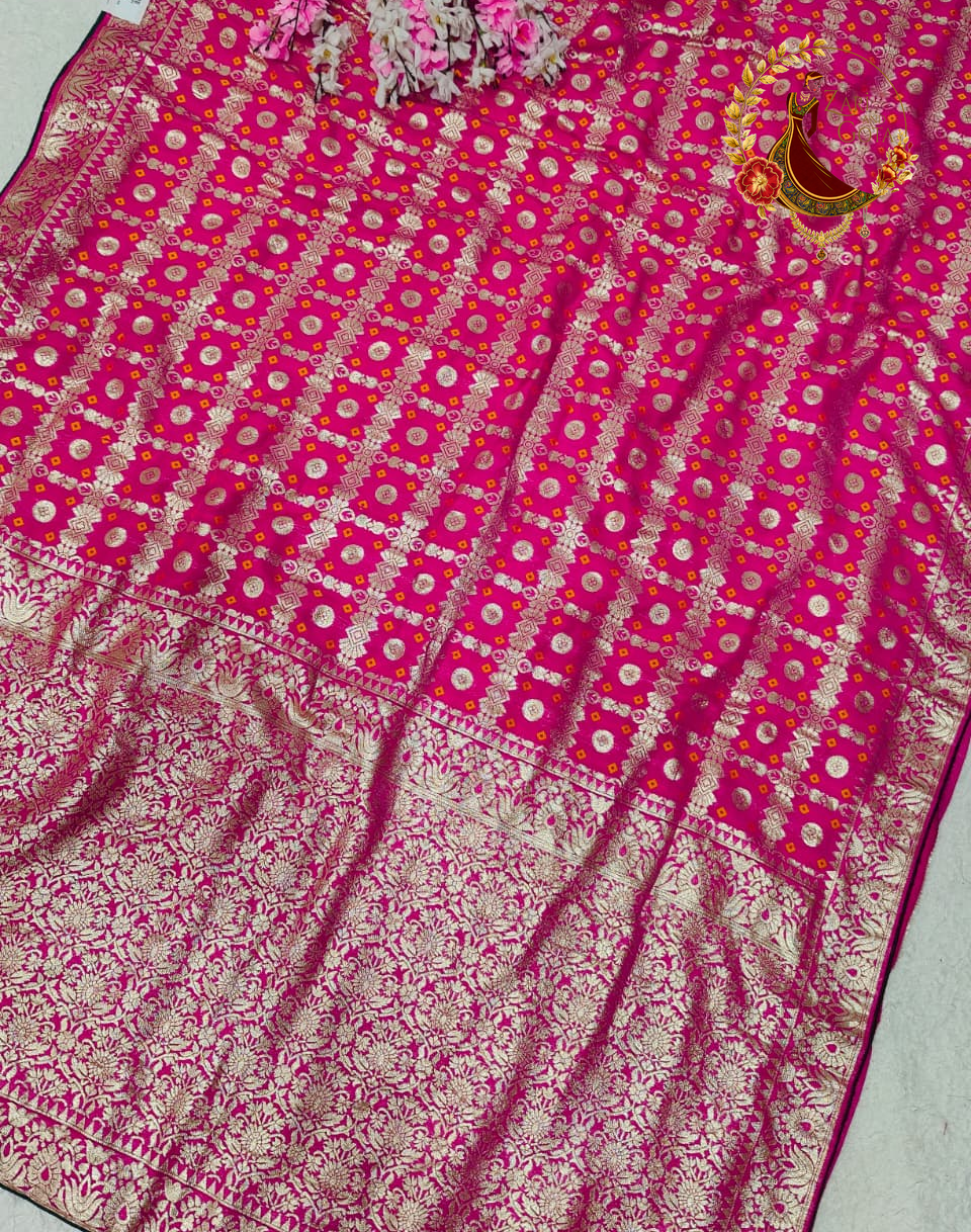 Gold zari disc motifs across the rani pink Dola silk body and pallu