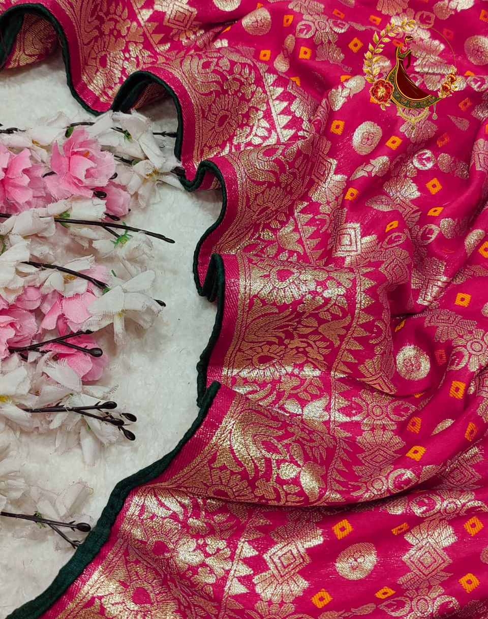 Scalloped gold zari border of the rani pink Dola silk saree