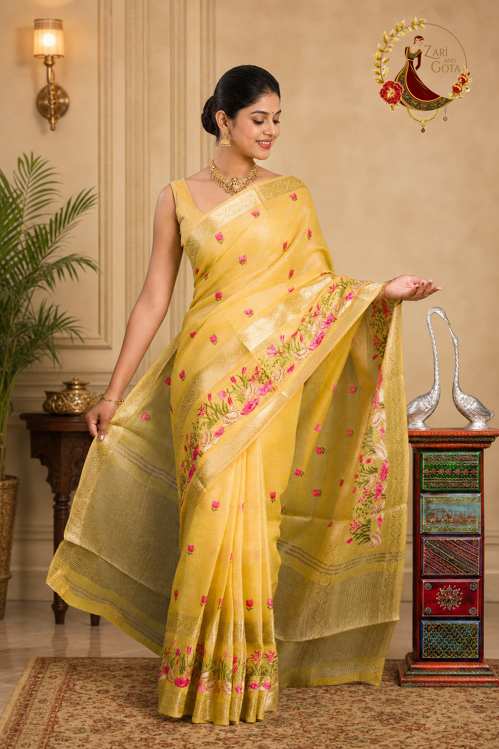 Golden yellow tissue cotton saree with the pallu held open to show the gold border