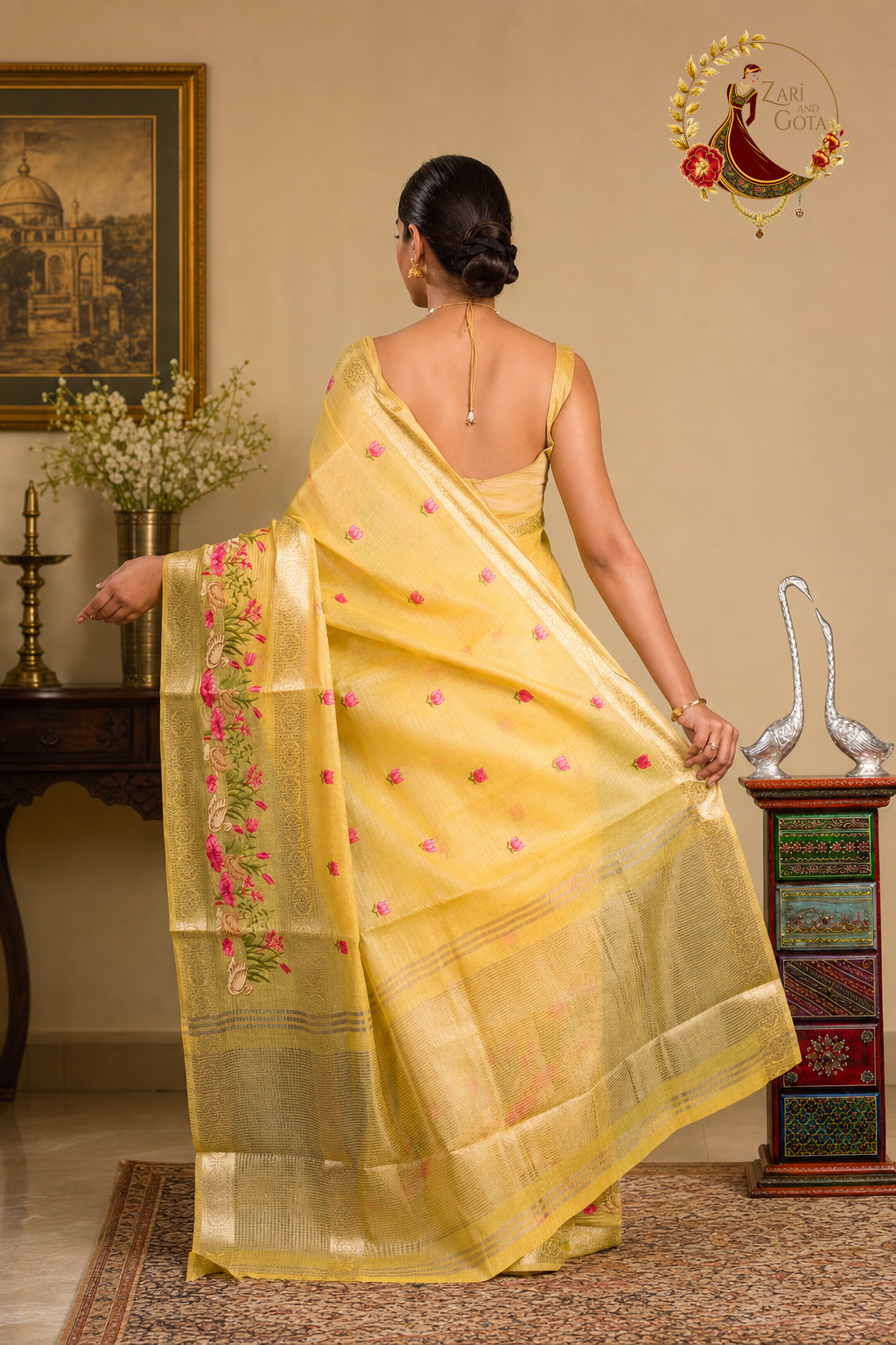 Back view of the golden yellow saree showing the striped gold zari pallu ends