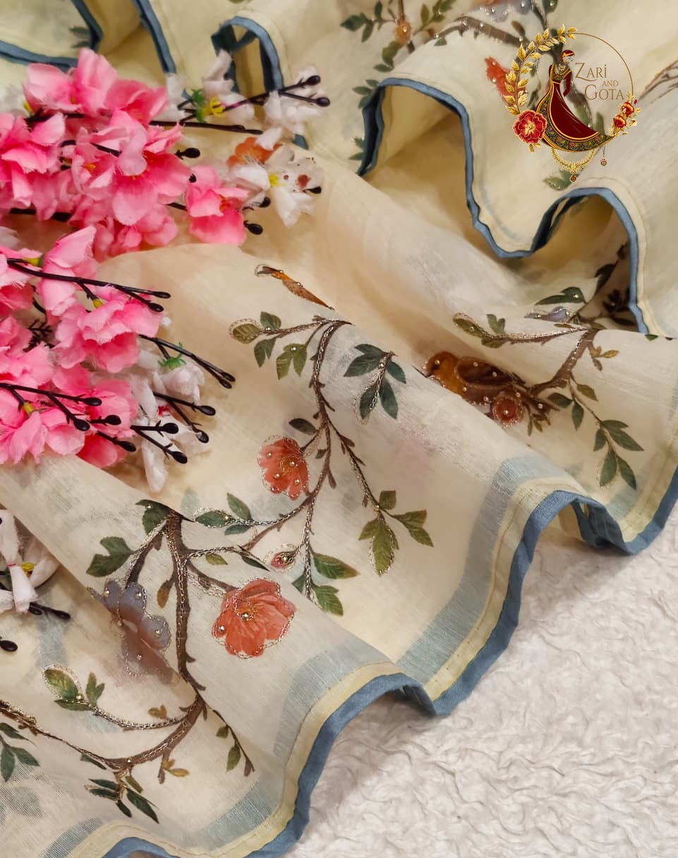 Printed floral branch and bird motifs on cream cotton silk with a blue border stripe