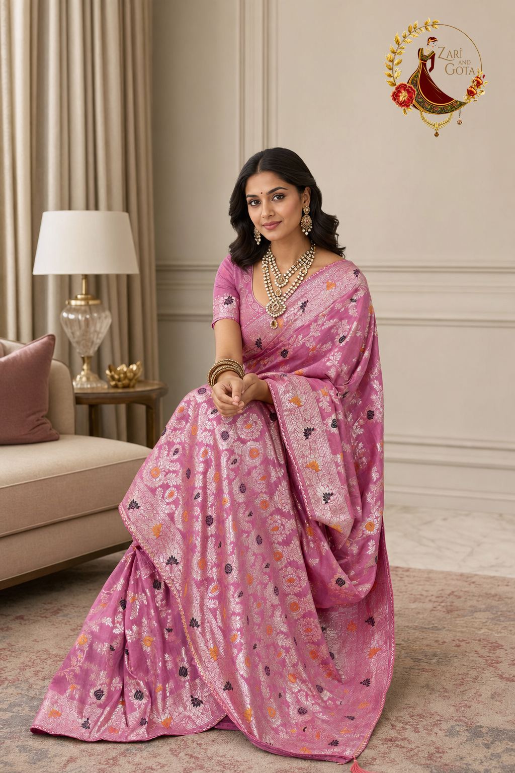 Seated view of the rose pink Dola silk saree showing the woven pallu panel