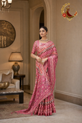Rose pink geometric print cotton silk saree with zari-edged border, worn by a model