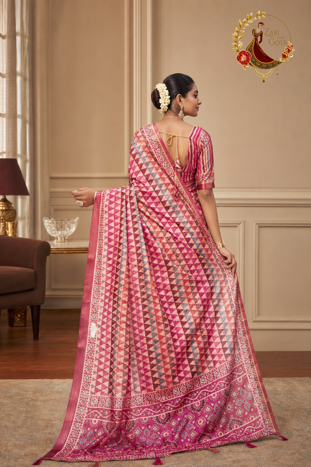 Back view of the rose pink printed saree with the pallu spread