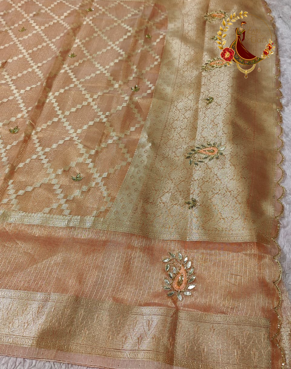 Peach tissue saree laid flat showing the lattice ground and beaded motifs